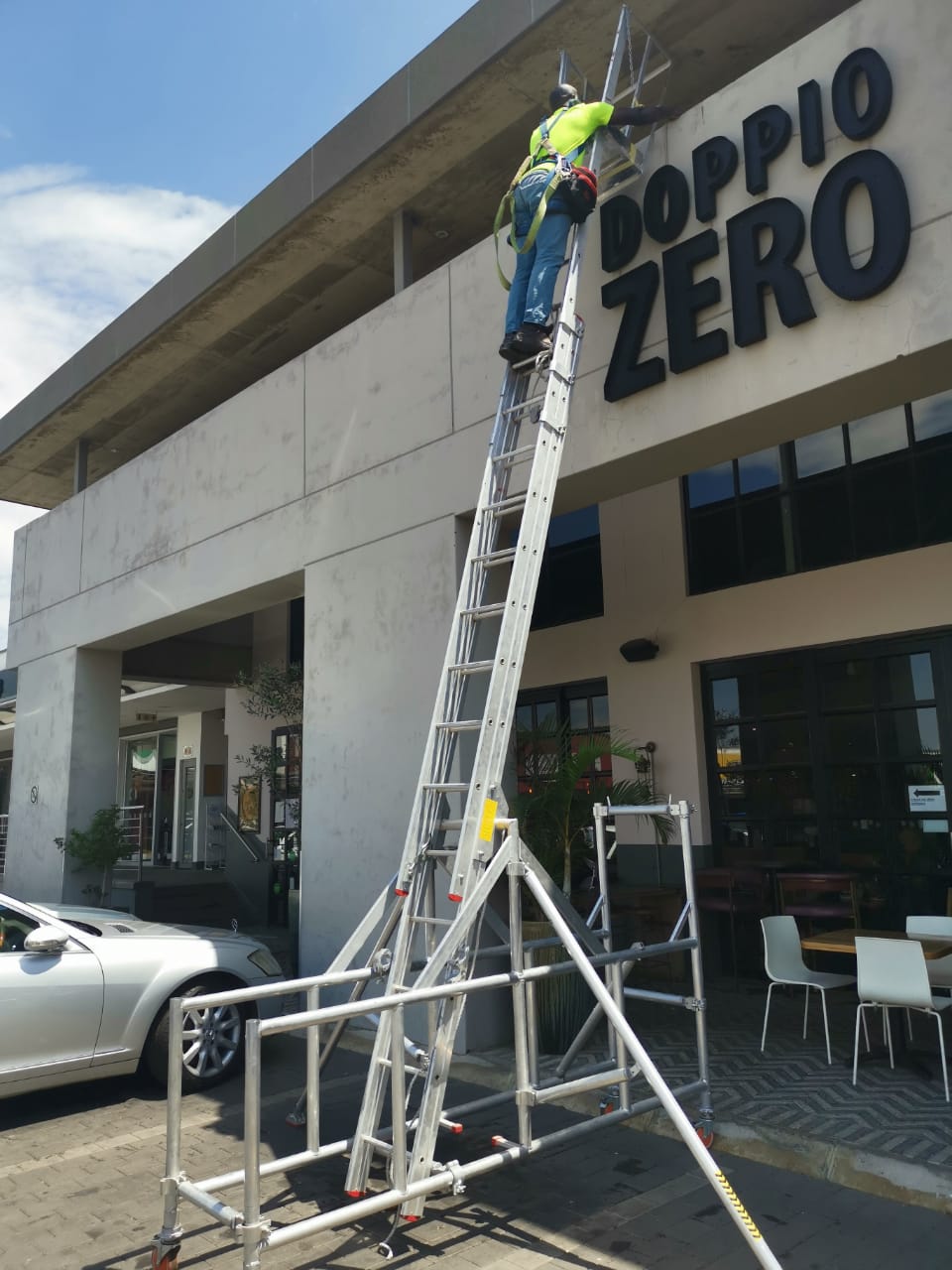 worker servicing neon sign